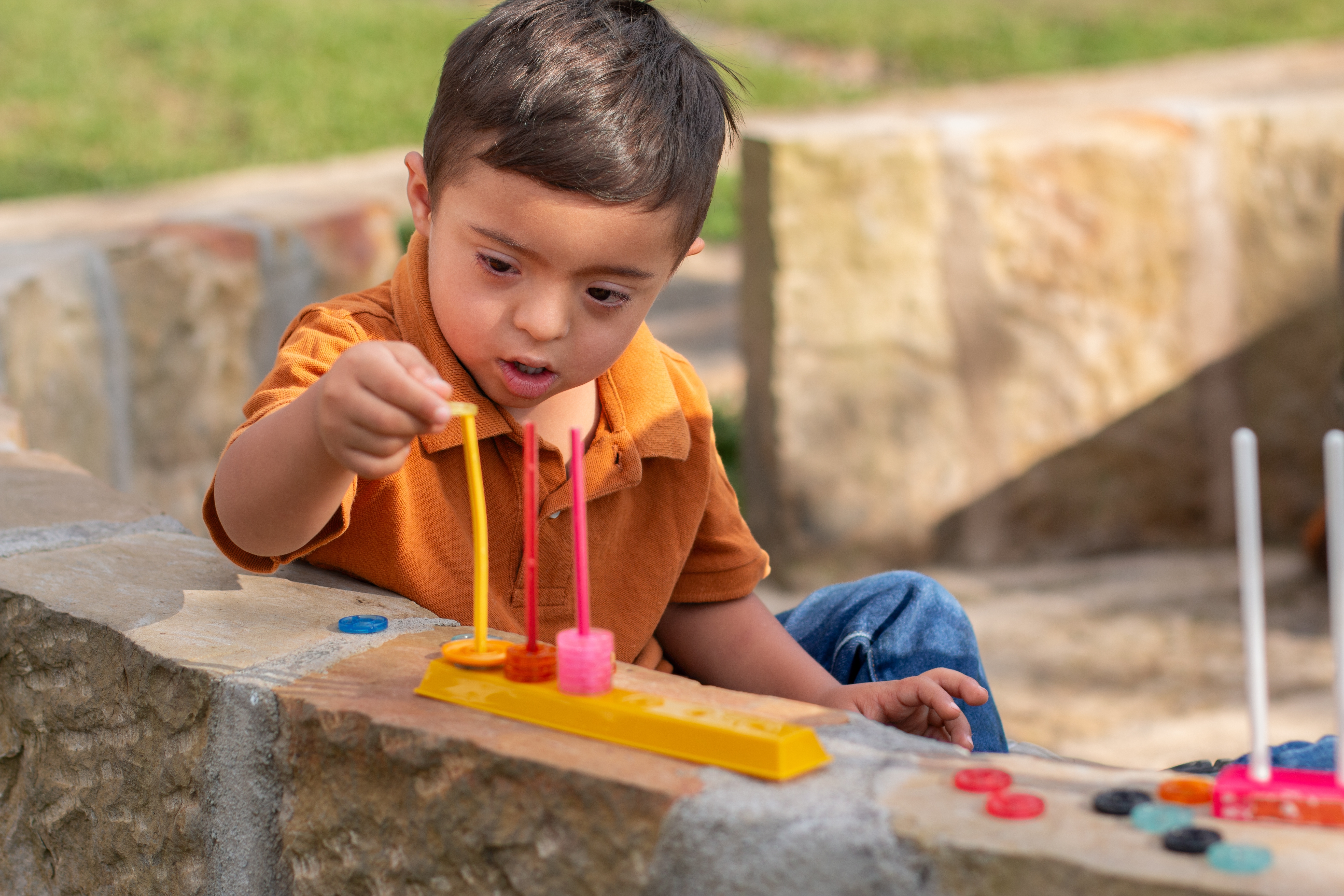 toddler uses manipulatives outside